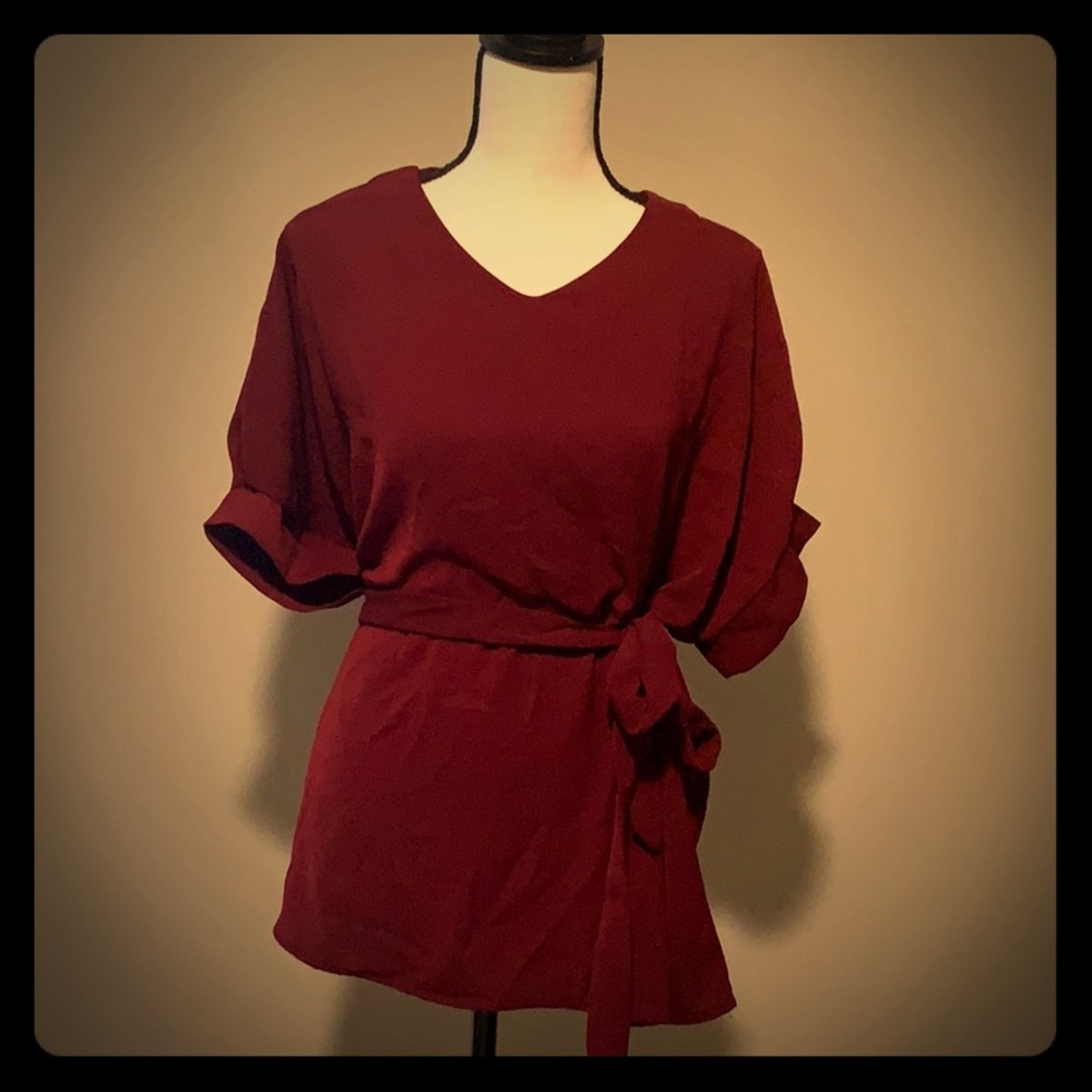 Wine colored blouse, ties around the waist